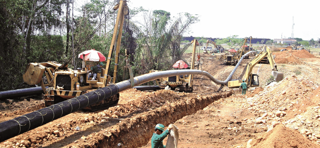 Pipeline construction with crew and machinery in an open trench