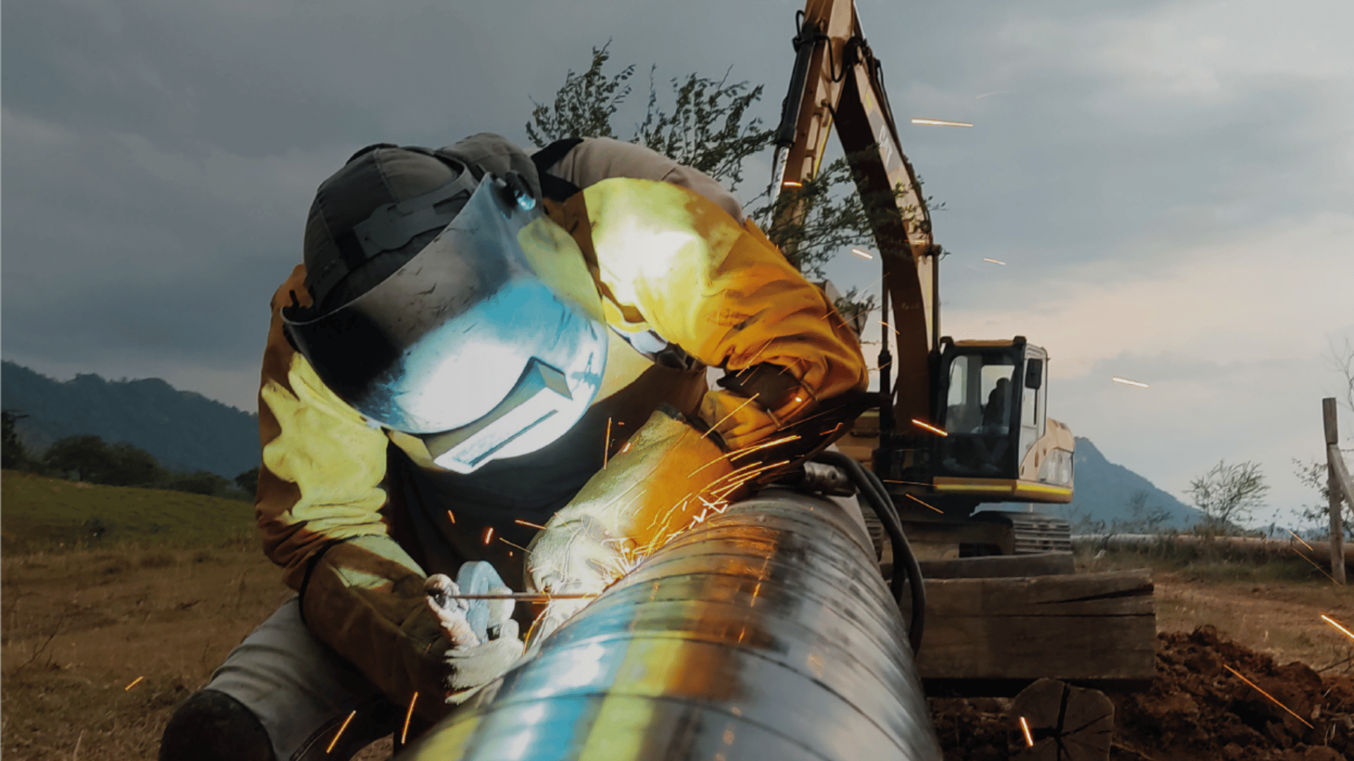 Welding a joint on steel pipe during pipeline construction